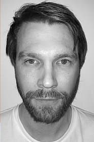 Michael Homick as Kwei (Suit)