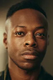 Durassie Kiangangu as Axia Restaurant Waiter