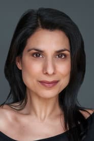 Laara Sadiq as British Newscaster
